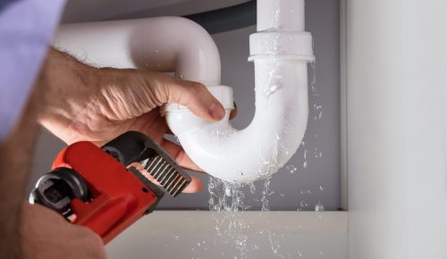 Close-up,Of,Male,Plumber,Fixing,White,Sink,Pipe,With,Adjustable
